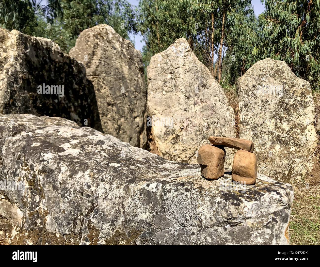 Small pebbles placed by modern hands on ancient standing stones at Complexo Megalítico do Rego da Murta, Portugal - Smartphone Captured Stock Image