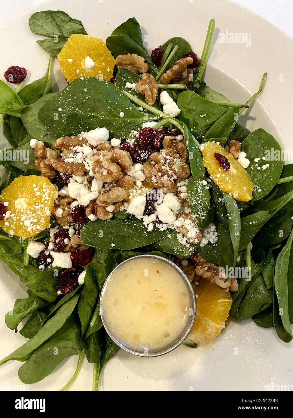 Spinach, salad with pecans, goat cheese, and oranges. - Smartphone Captured Stock Image