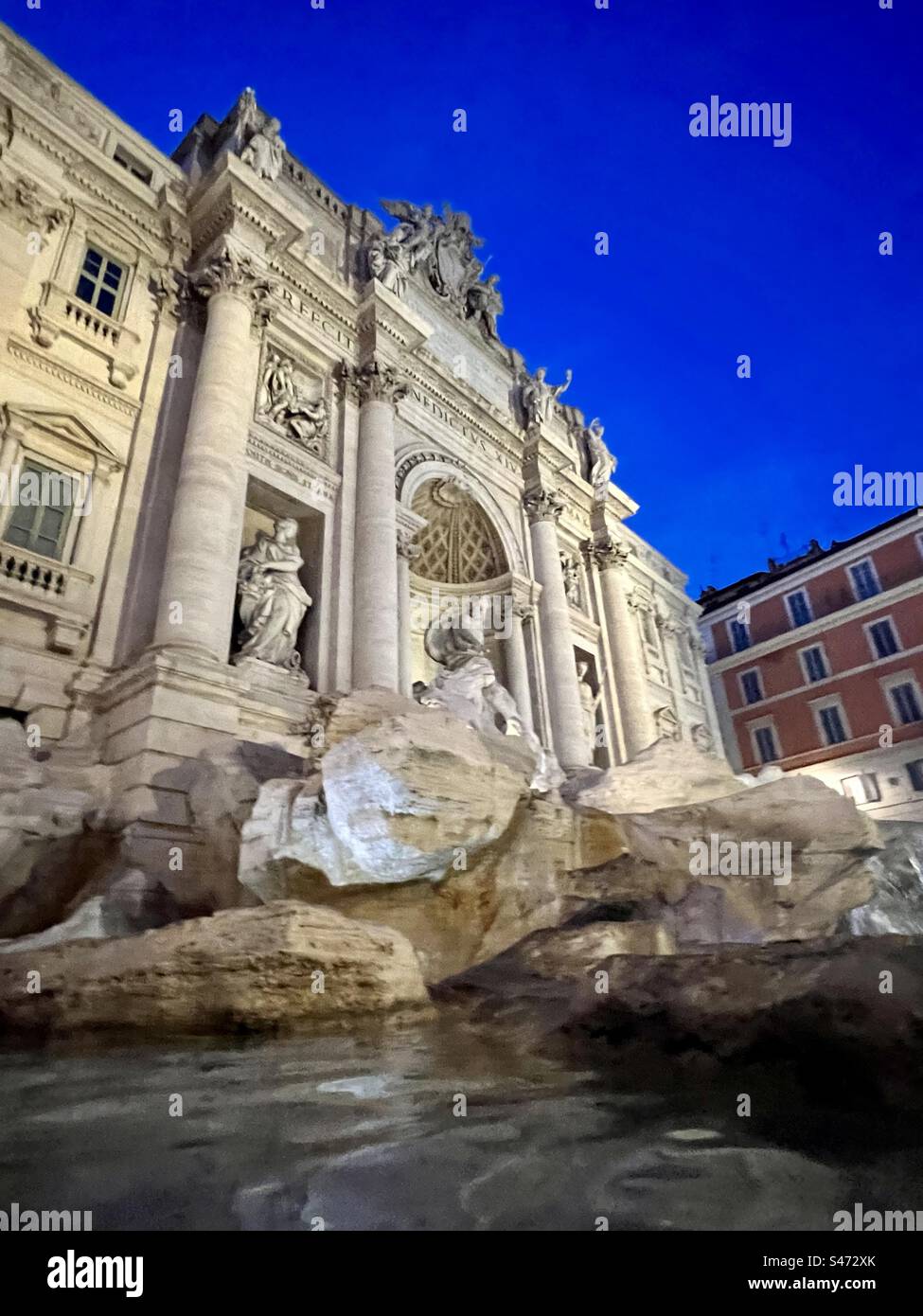 Trevi Fountain against a deep blue night sky  in Rome - Smartphone Captured Stock Image