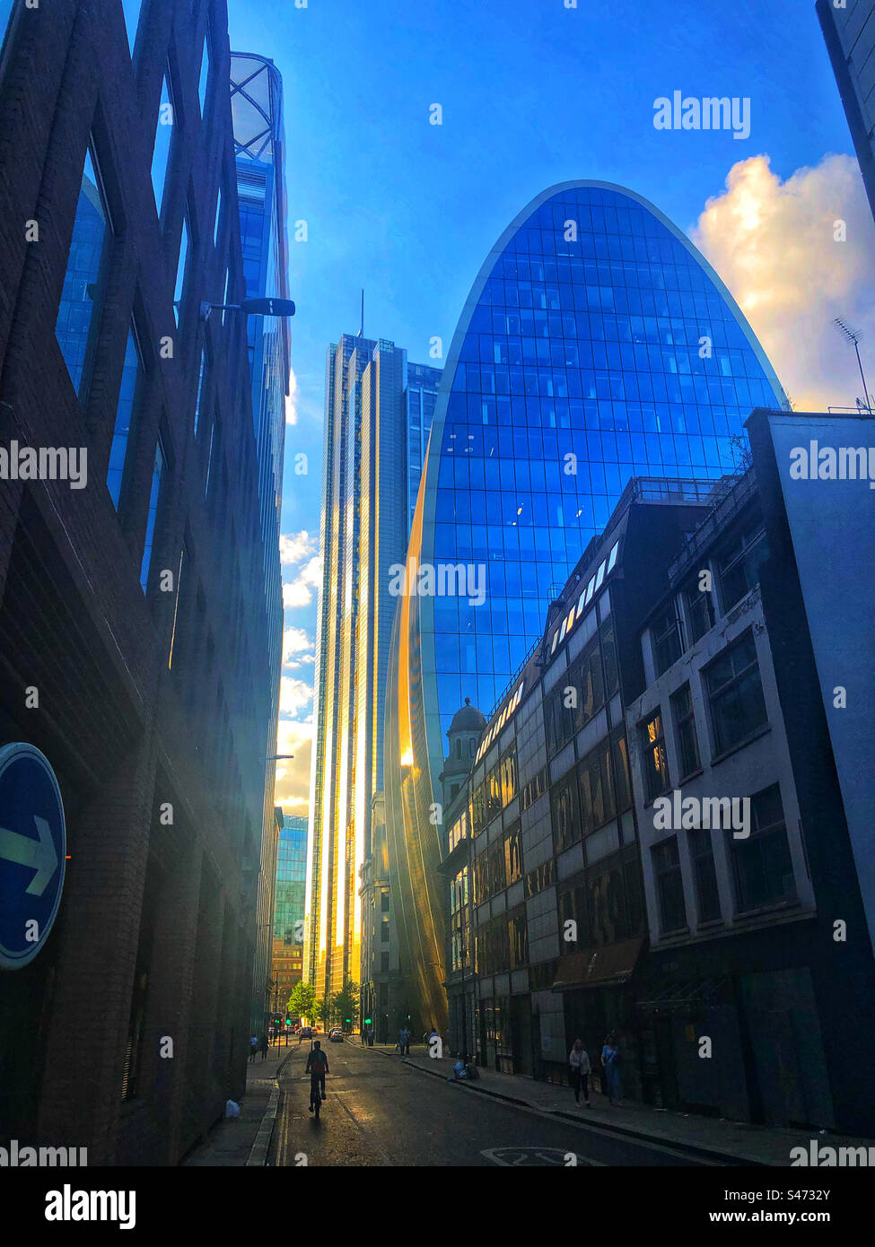Cyclist and pedestrians dwarfed by tall building in London - Smartphone Captured Stock Image