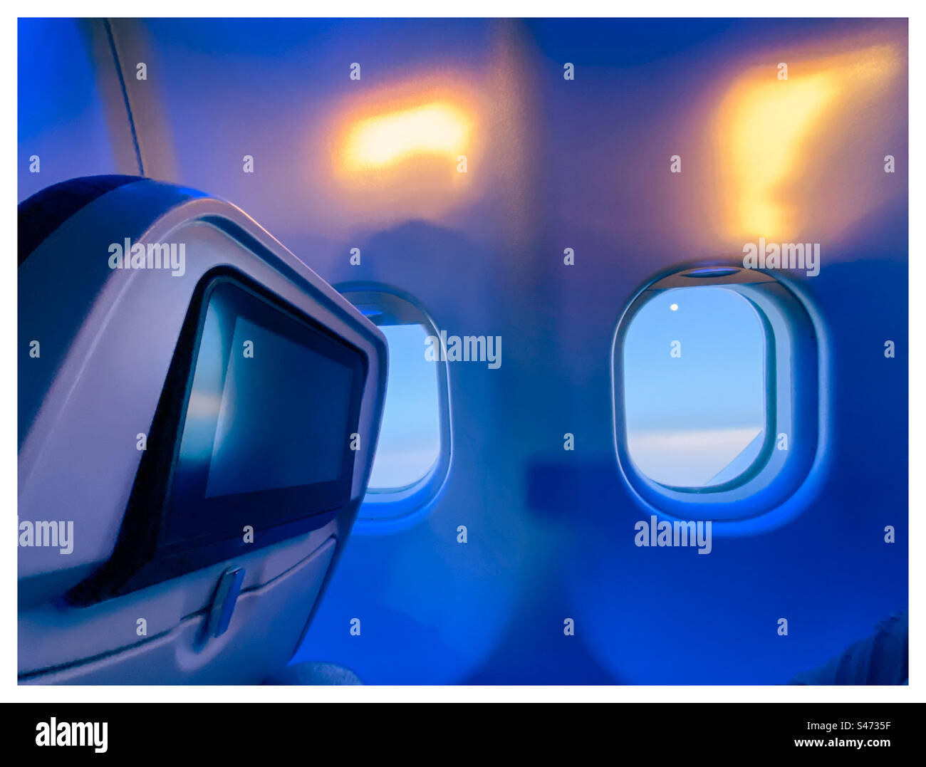 Blue lights wake people up on a long haul flight to Windhoek Stock Photo