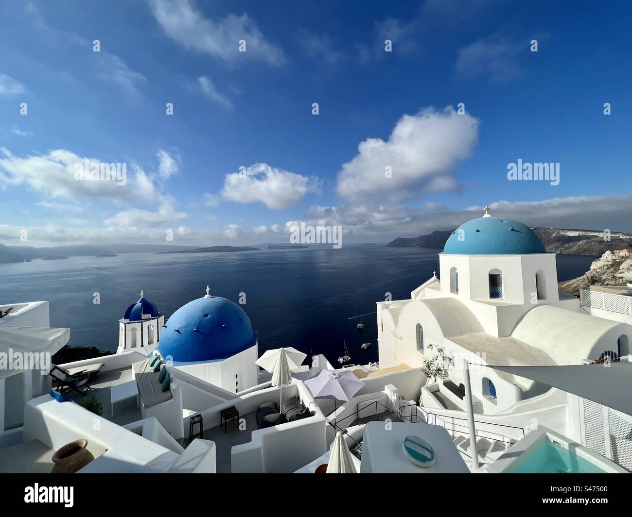 Summer morning view of the blue domes in Oia and Aegean Sea - Smartphone Captured Stock Image