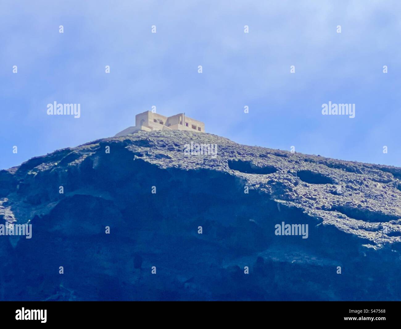 Building on top of the tick coastline of the southern part of Santorini island - Smartphone Captured Stock Image