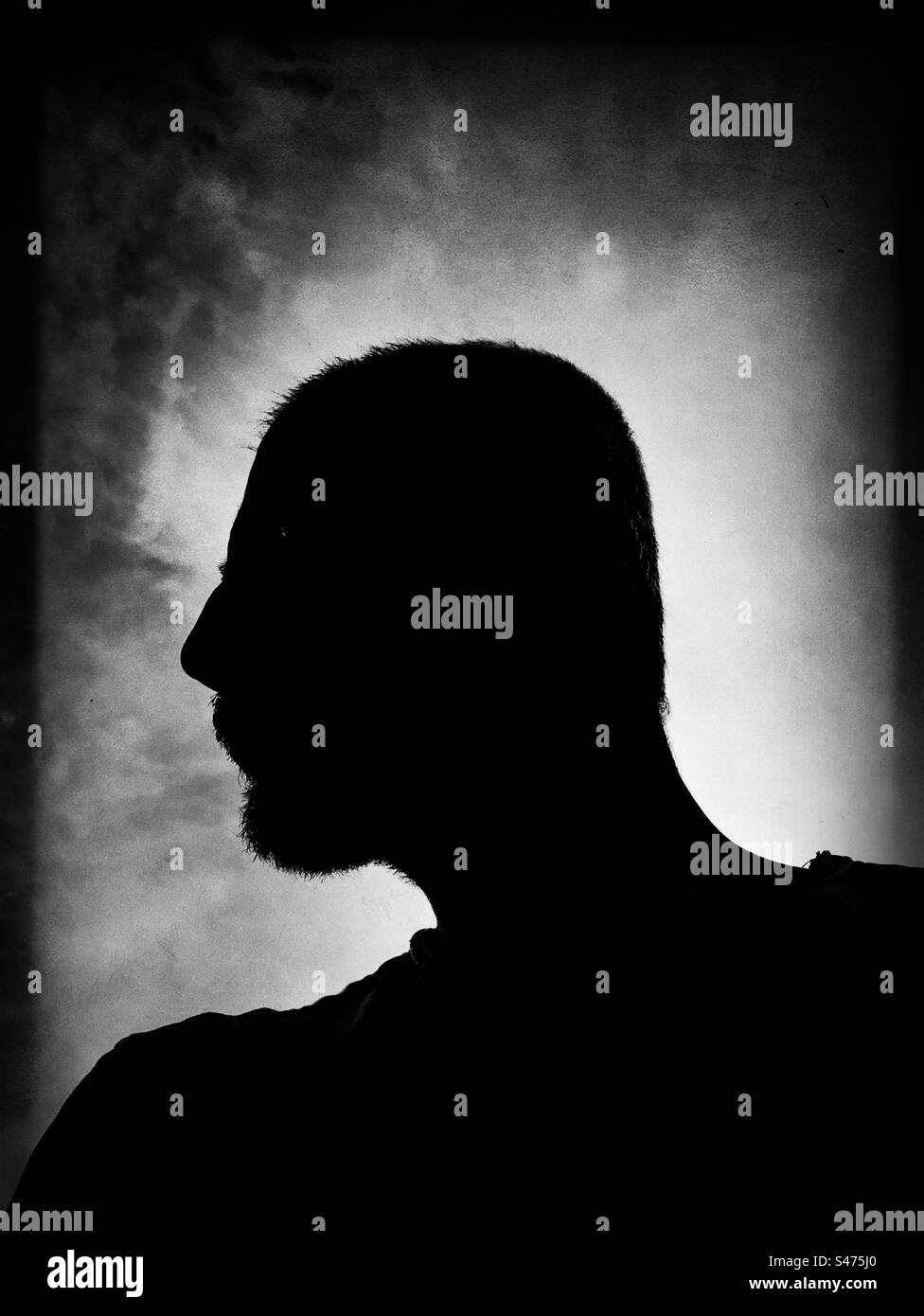 Dramatic silhouette of a man photographed from profile Stock Photo
