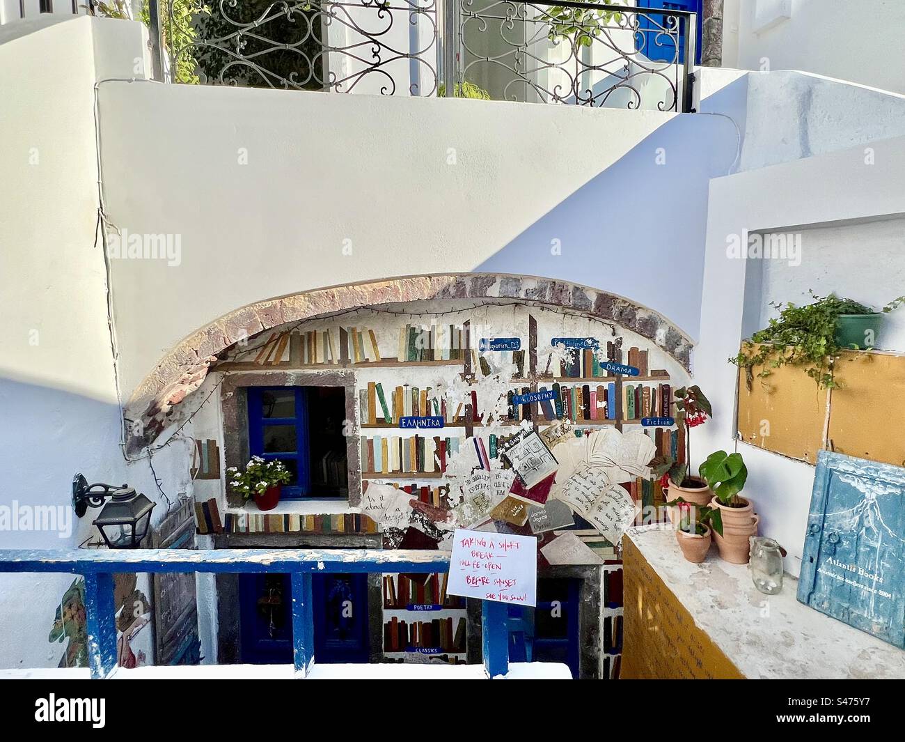 A colorful, cheery exterior of bookstore against the neutral structures. Oia, Santorini - Smartphone Captured Stock Image