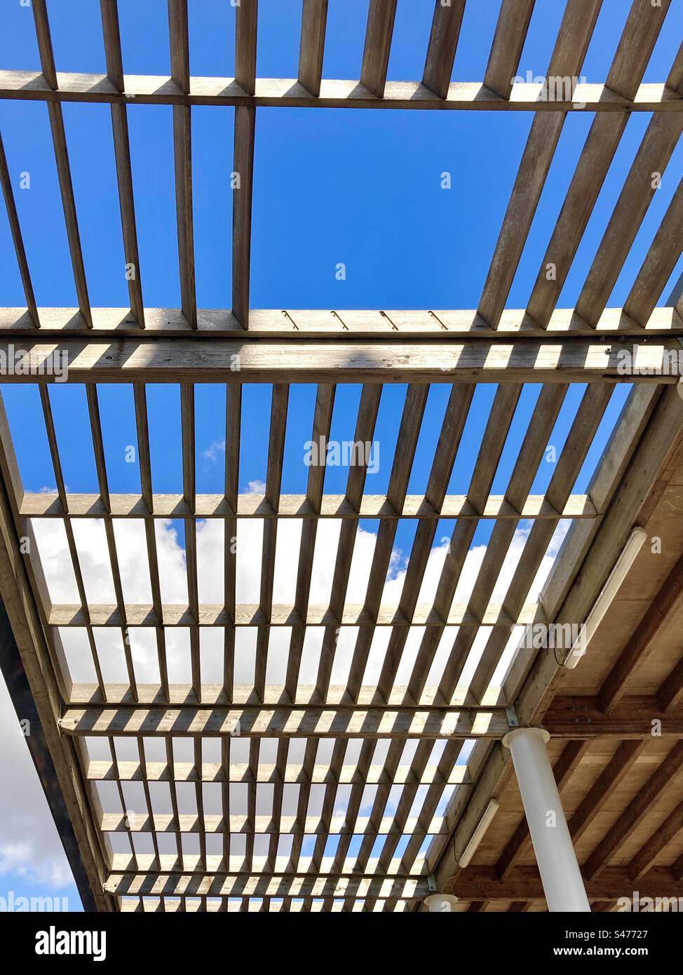 Wooden lattice over parking at a petrol service station in France - Smartphone Captured Stock Image