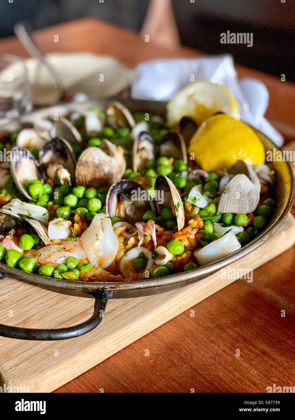 Spanish seafood paella served in a skillet, ready to eat. Stock Photo