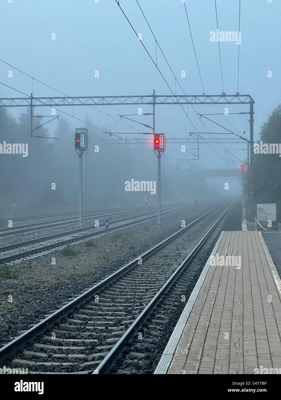 Railway platform on a foggy morning, Kempele Finland Stock Photo