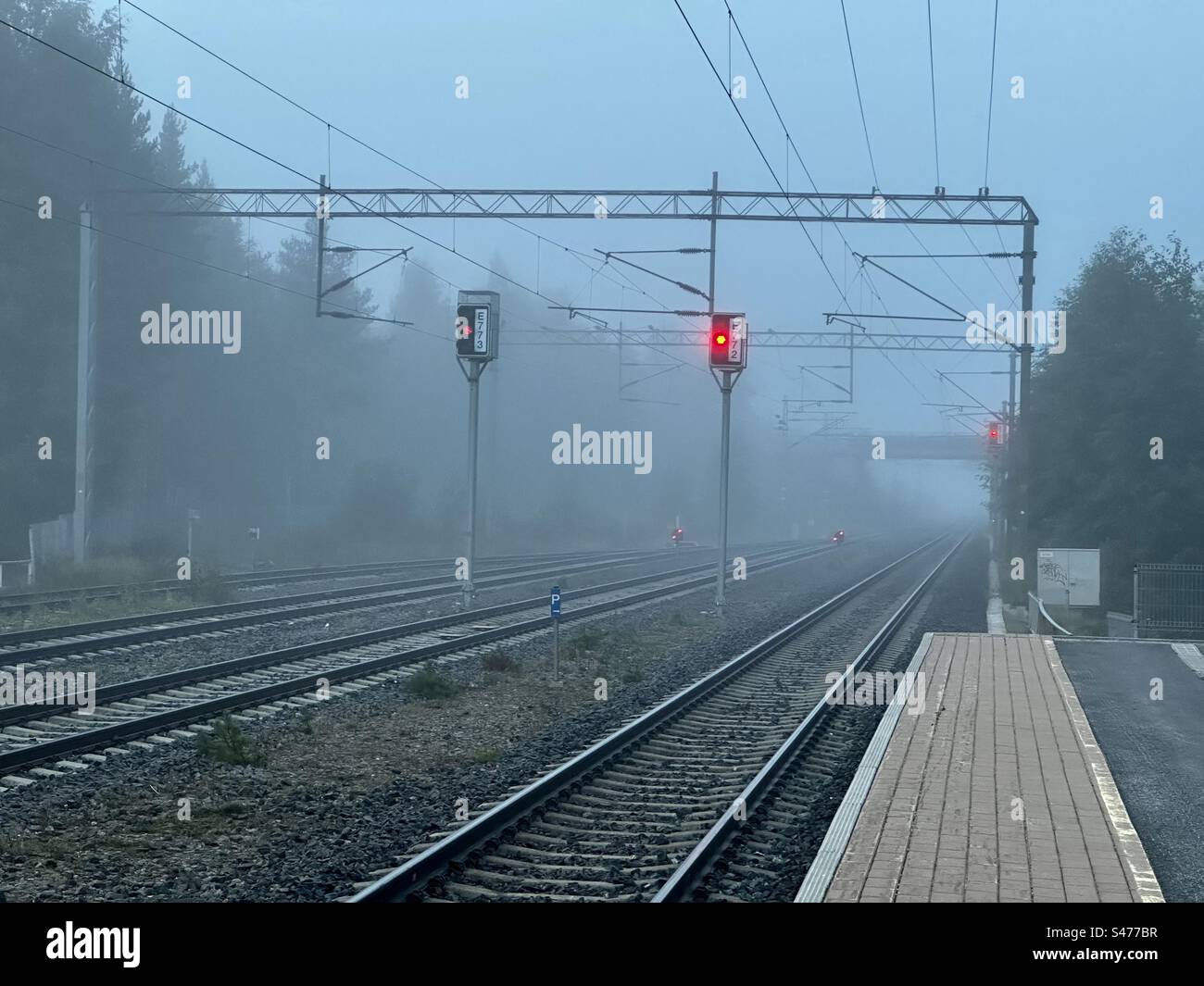 Railway platform on a foggy morning,Kempele Finland Stock Photo