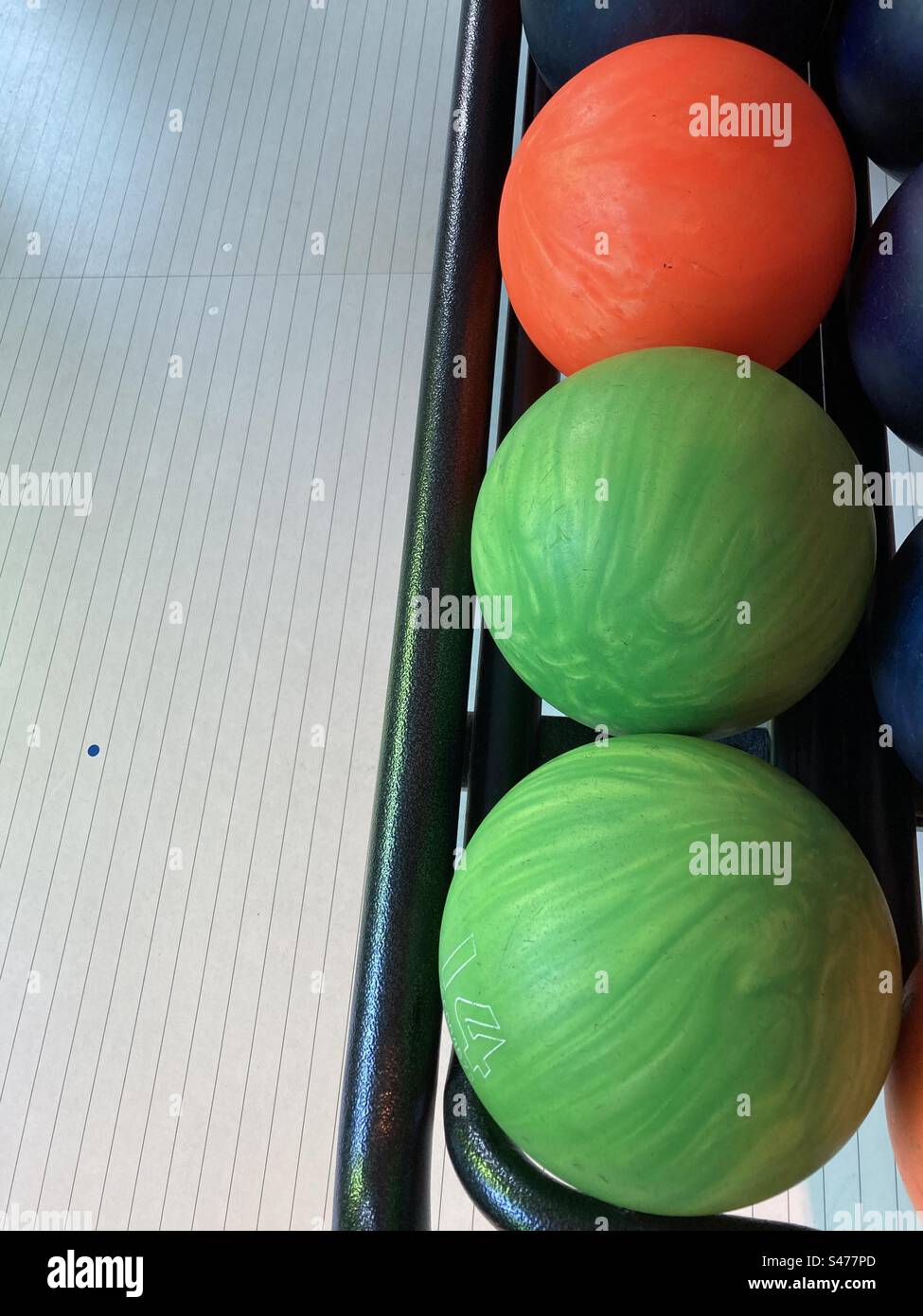 Three colorful bowling balls lie in a row - Smartphone Captured Stock Image