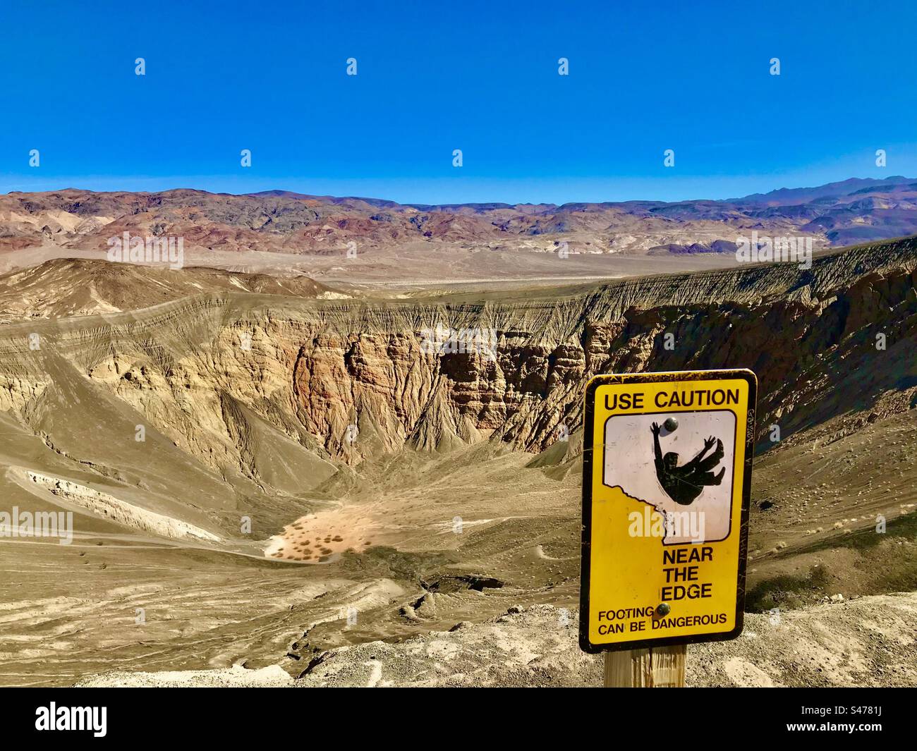 Use caution bear the edge! Footing can be dangerous at Ubehebe Crater in Death Valley National Park. Stock Photo