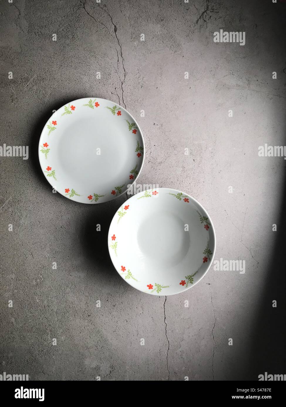 Top view of an empty plate and bowl on a table - Smartphone Captured Stock Image