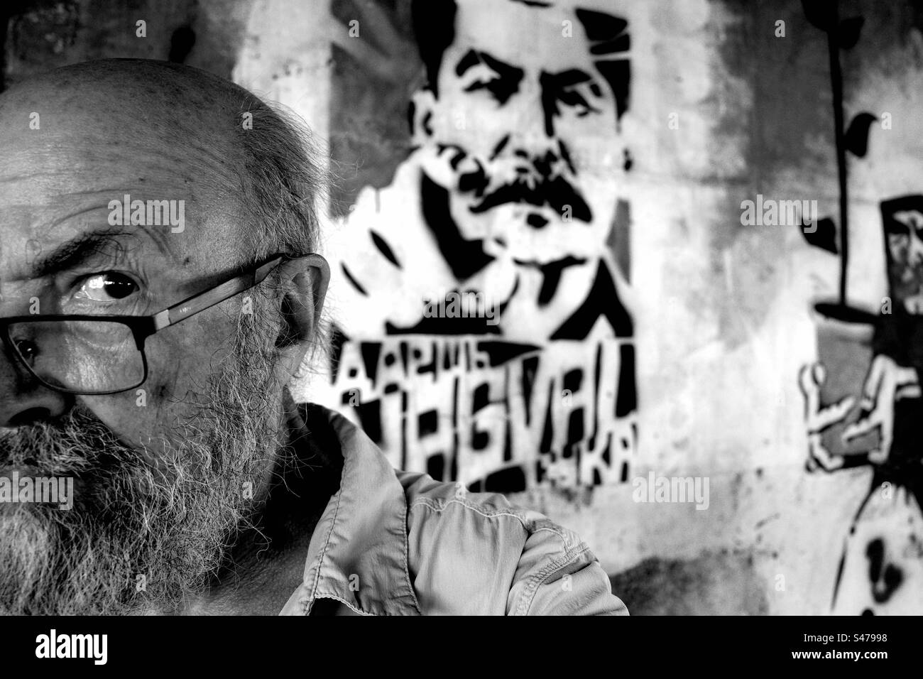 Senior man against graffiti of Staline Stock Photo