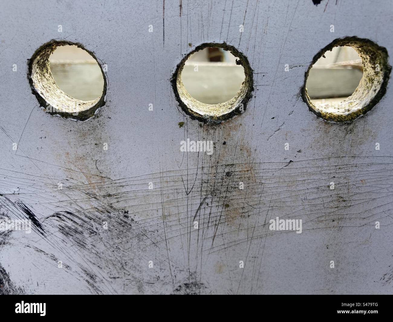 Round holes in a gray wooden board - Smartphone Captured Stock Image