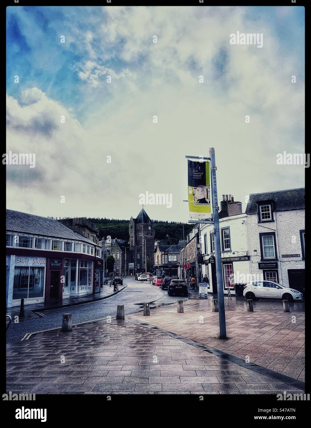 Galashiels town centre on a wet day with the town clock and war memorial. Stock Photo
