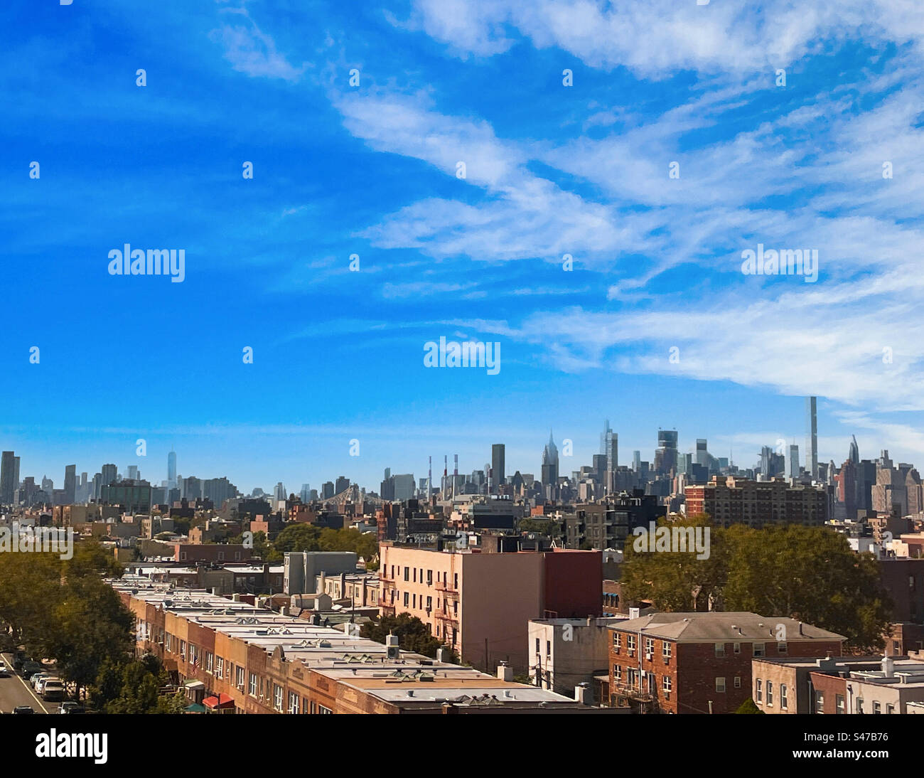 Skyscrapers and super talls in the Manhattan skyline as seen from an Amtrak train window, traveling through the borough of Queens, 2023, New York City, United States - Smartphone Captured Stock Image