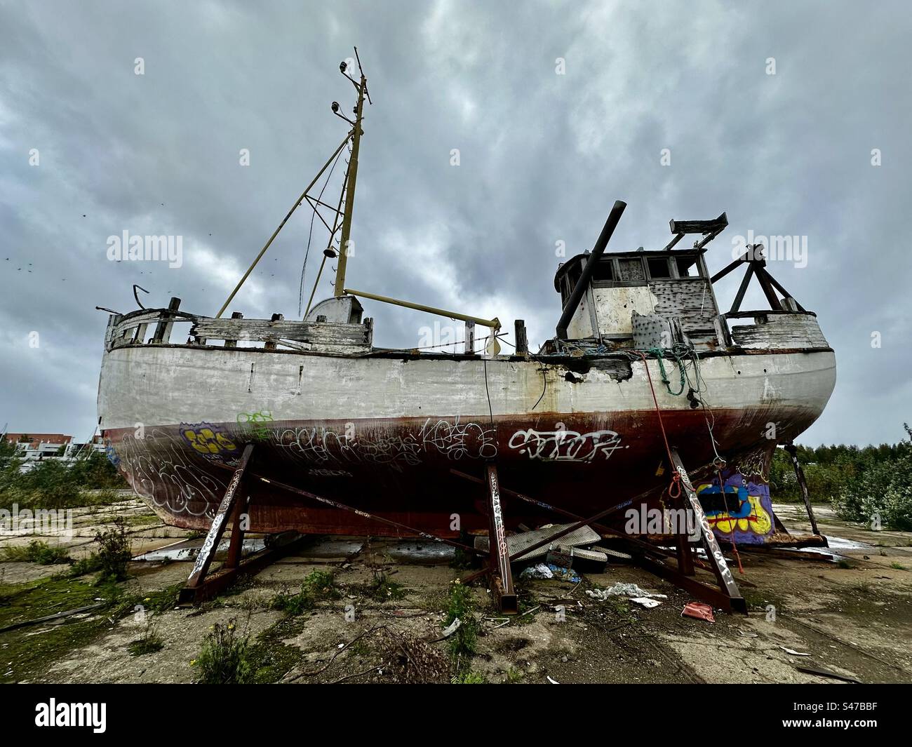 Derelict fishing boat on land Stock Photo - Alamy