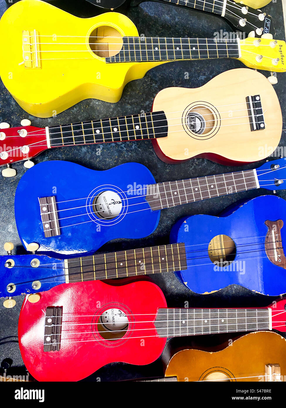 Colourful ukulele string instruments. - Smartphone Captured Stock Image