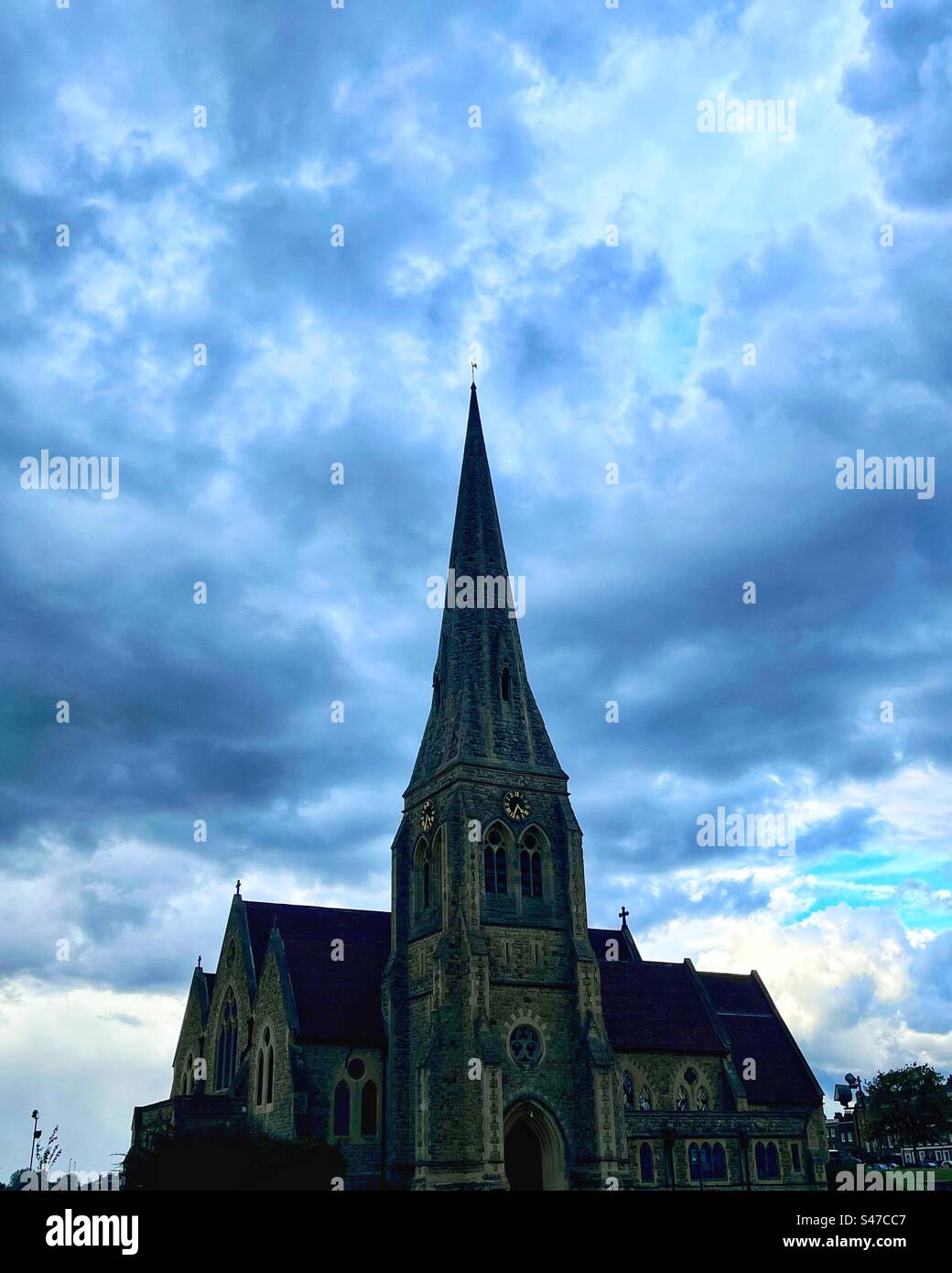 All Saints Church on Blackheath in London - perspective - storm clouds and spire. Stock Photo