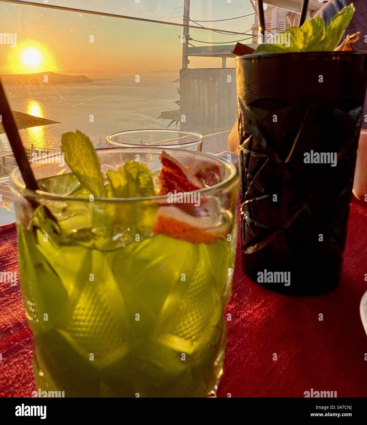 Cocktails at sunset on viewed from Fira, Santorini - Smartphone Captured Stock Image