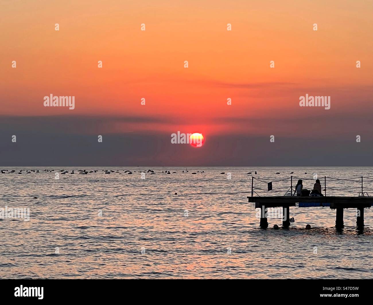 Sunset by the sea Stock Photo - Alamy