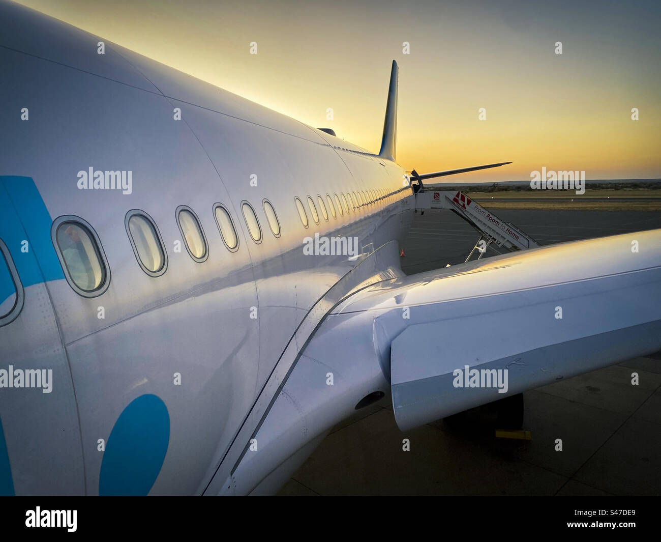 Close view of an aircraft on the runway as the sun sets in Windhoek Namibia - Smartphone Captured Stock Image