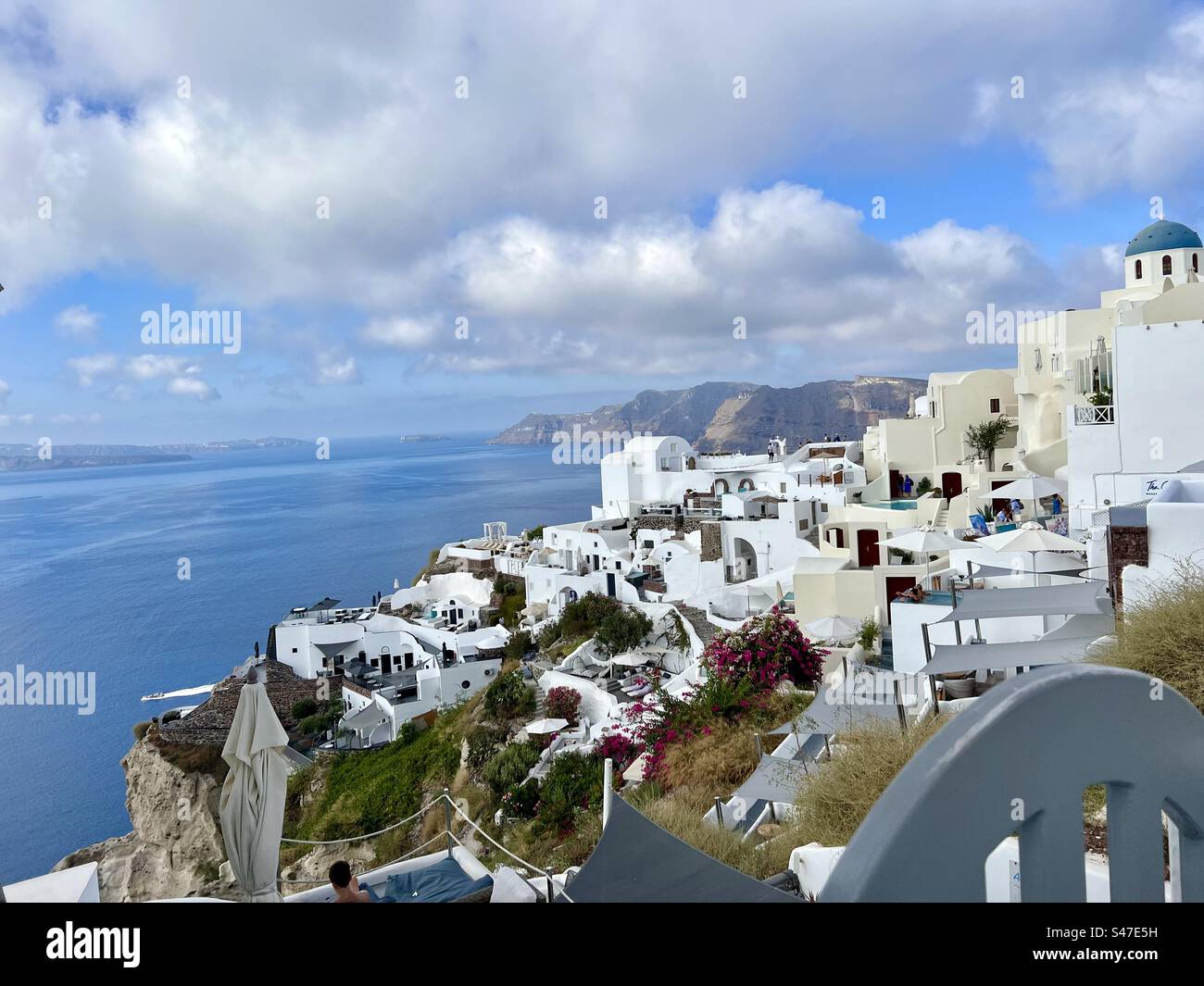 View from Oia village on Santorini looking down the slopes side into the caldera below. - Smartphone Captured Stock Image