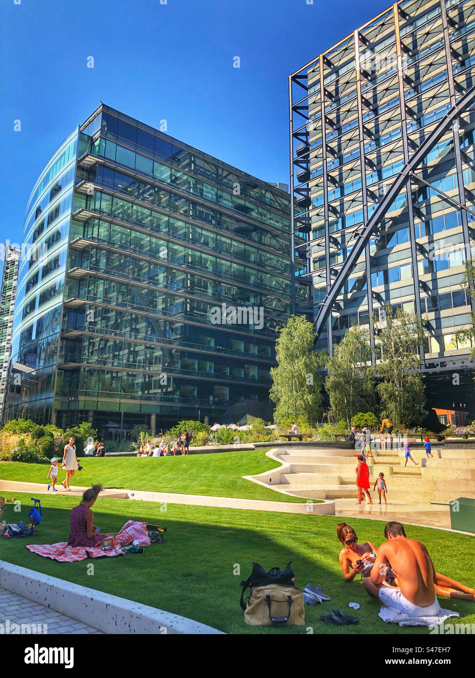 People relaxing in Exchange Square, Broadgate on a glorious summers day during August 2022 - Smartphone Captured Stock Image