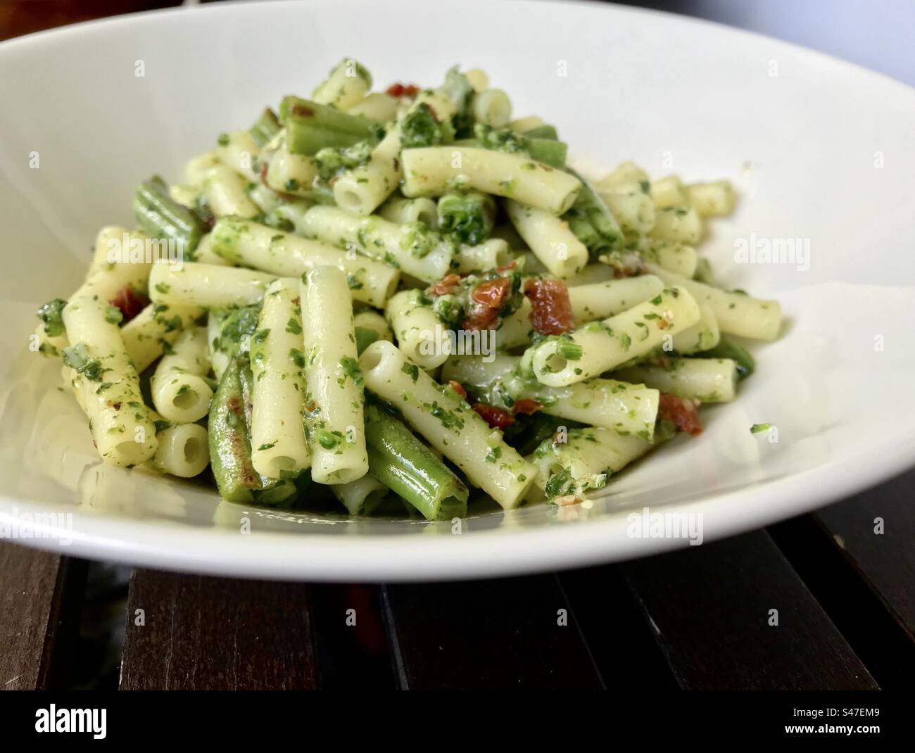 Low fodmap meal containing gluten free pasta, green beans, herbs and tomatoes. - Smartphone Captured Stock Image