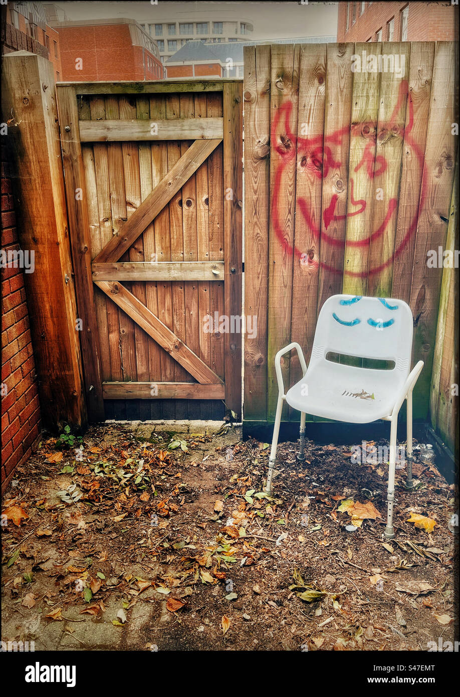 Abandoned chair with painted eyes - Smartphone Captured Stock Image