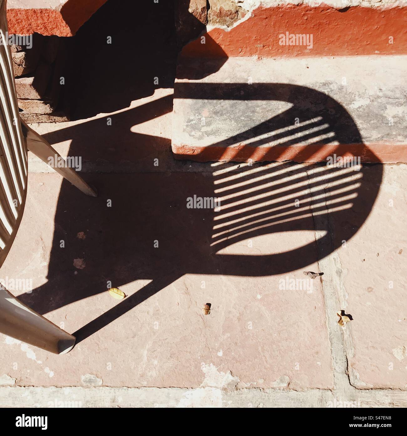 A shadow of a chair on the ground - Smartphone Captured Stock Image