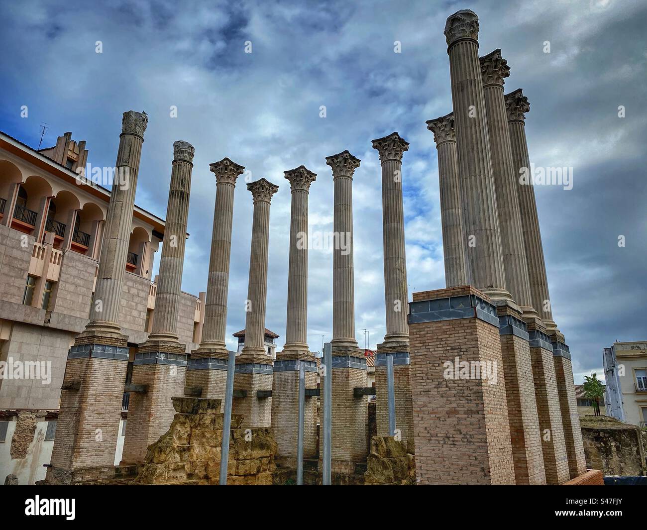 Columns of ancient Roman Temple with cloudy sky in the background in Córdoba, Spain. - Smartphone Captured Stock Image
