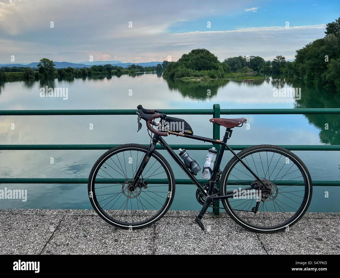 Bicycle parked on a bridge. Isonzo river, Friuli Venezia Giulia, Italy - Smartphone Captured Stock Image