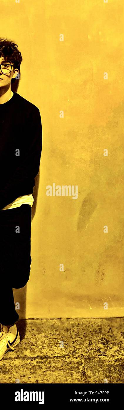 Half a young man in black and yellow. - Smartphone Captured Stock Image