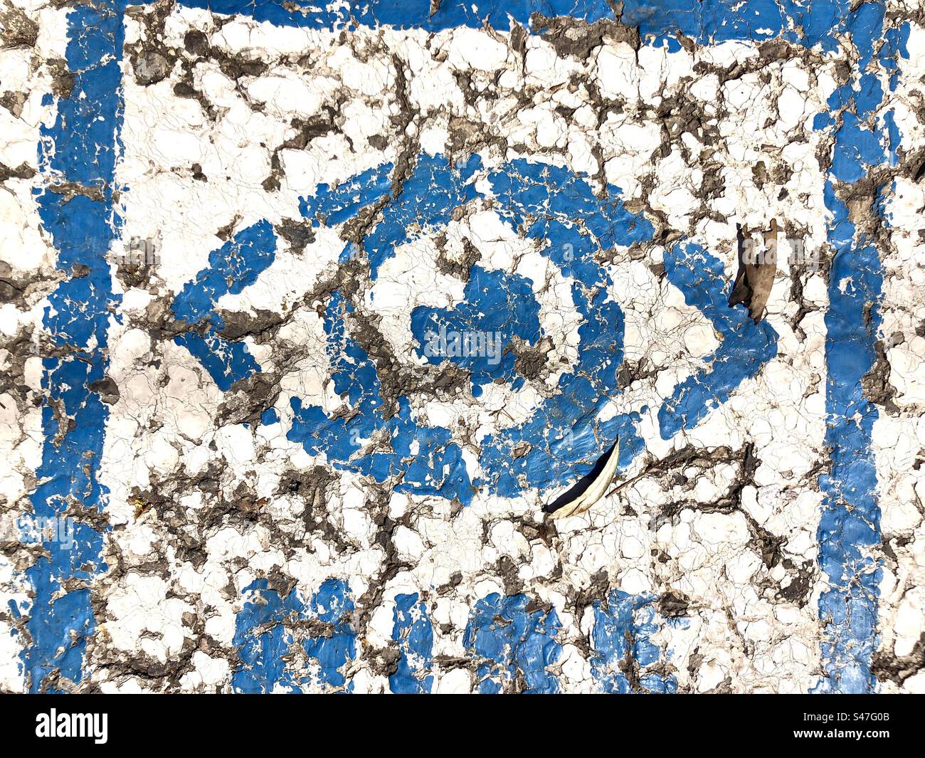 Stencil image of an eye on cracks surface of asphalt - Smartphone Captured Stock Image