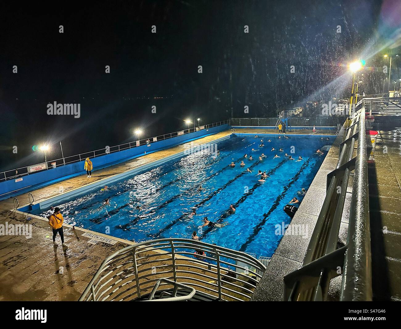 The final Starlight Swim of 2023 at Gourock Outdoor Pool, in the middle of Storm Agnes. Stock Photo