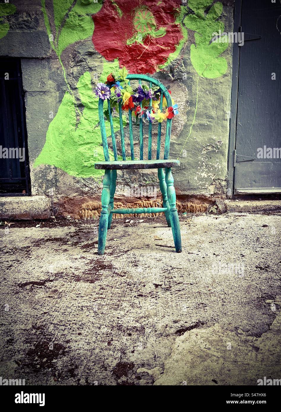 Antique chair adorned with artificial flowers. - Smartphone Captured Stock Image