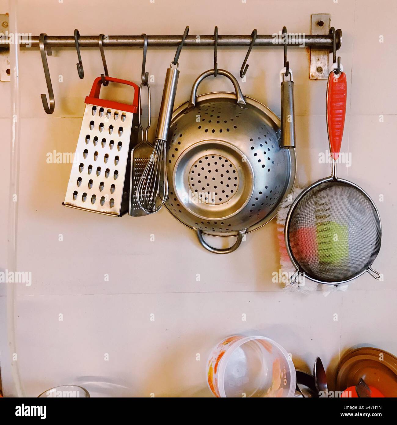 Cooking accessories hanging off hooks in the kitchen Stock Photo Alamy