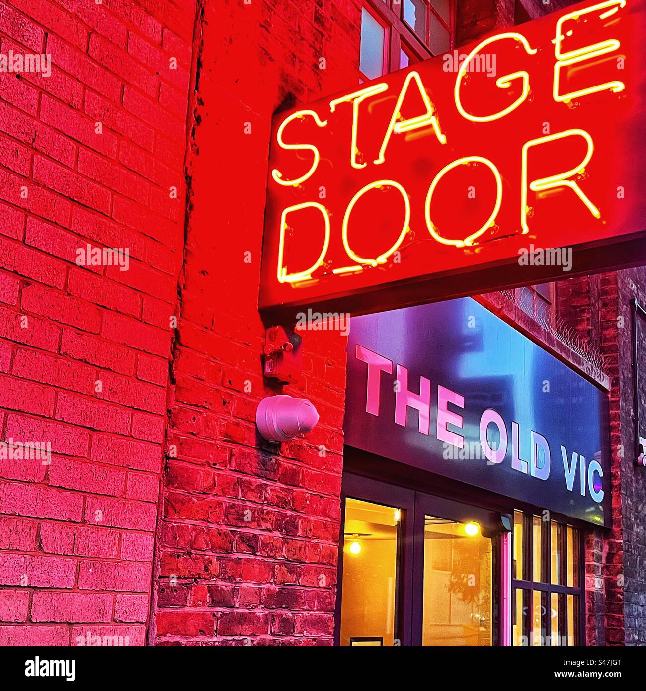 Red neon stage door sign at The Old Vic Theatre in London - Smartphone Captured Stock Image