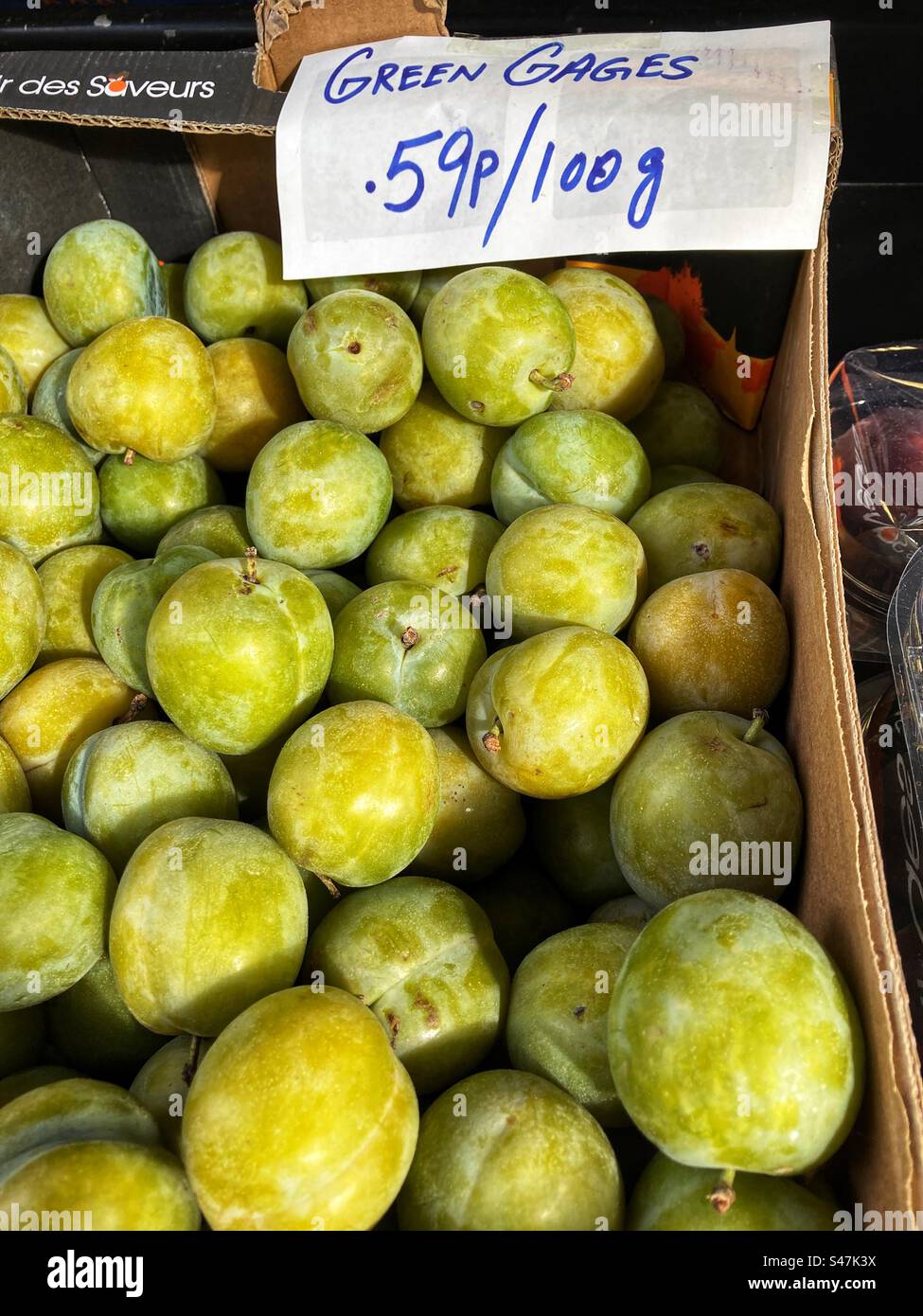 Greengages priced up for sale at Grocers shop - Smartphone Captured Stock Image