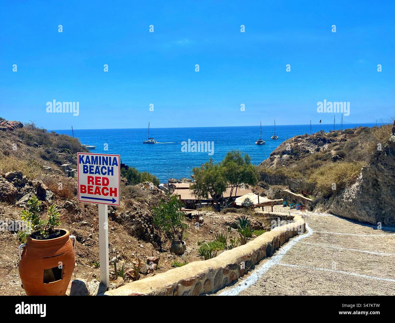 scenic view on downhill walking path to Kaminia Beach and Red Beach on Santorini island on a beautiful summer day. - Smartphone Captured Stock Image