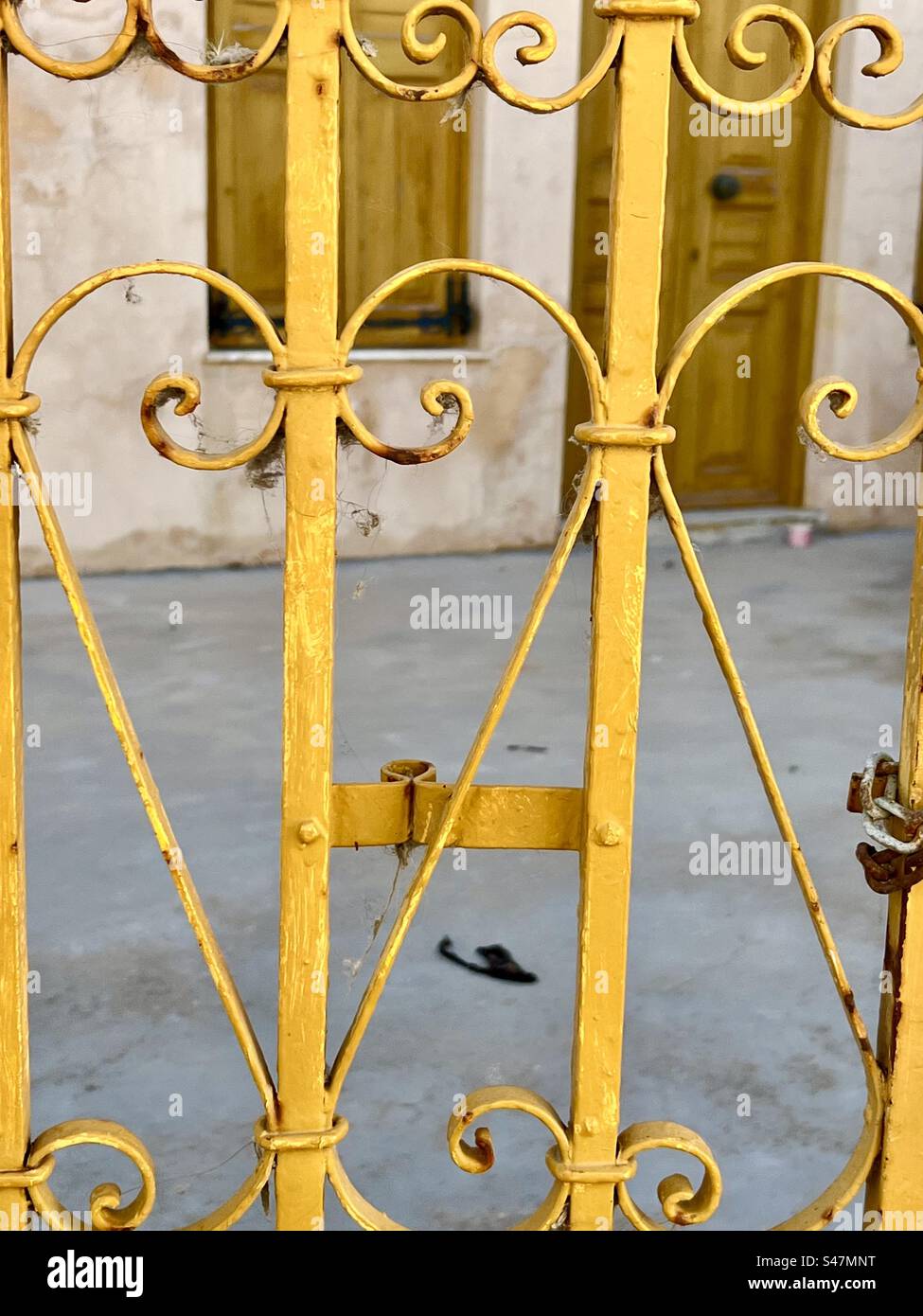 Scroll wrought iron fence painted yellow, Oia, Santorini - Smartphone Captured Stock Image