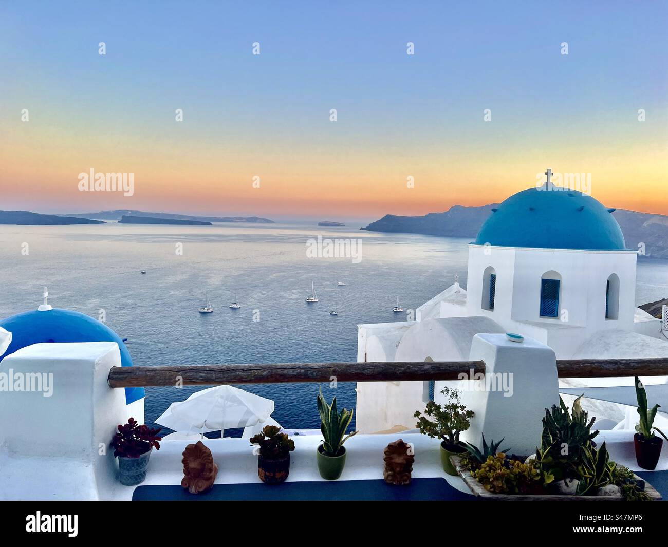 Blue domes of Oia, Santorini at sunset. - Smartphone Captured Stock Image