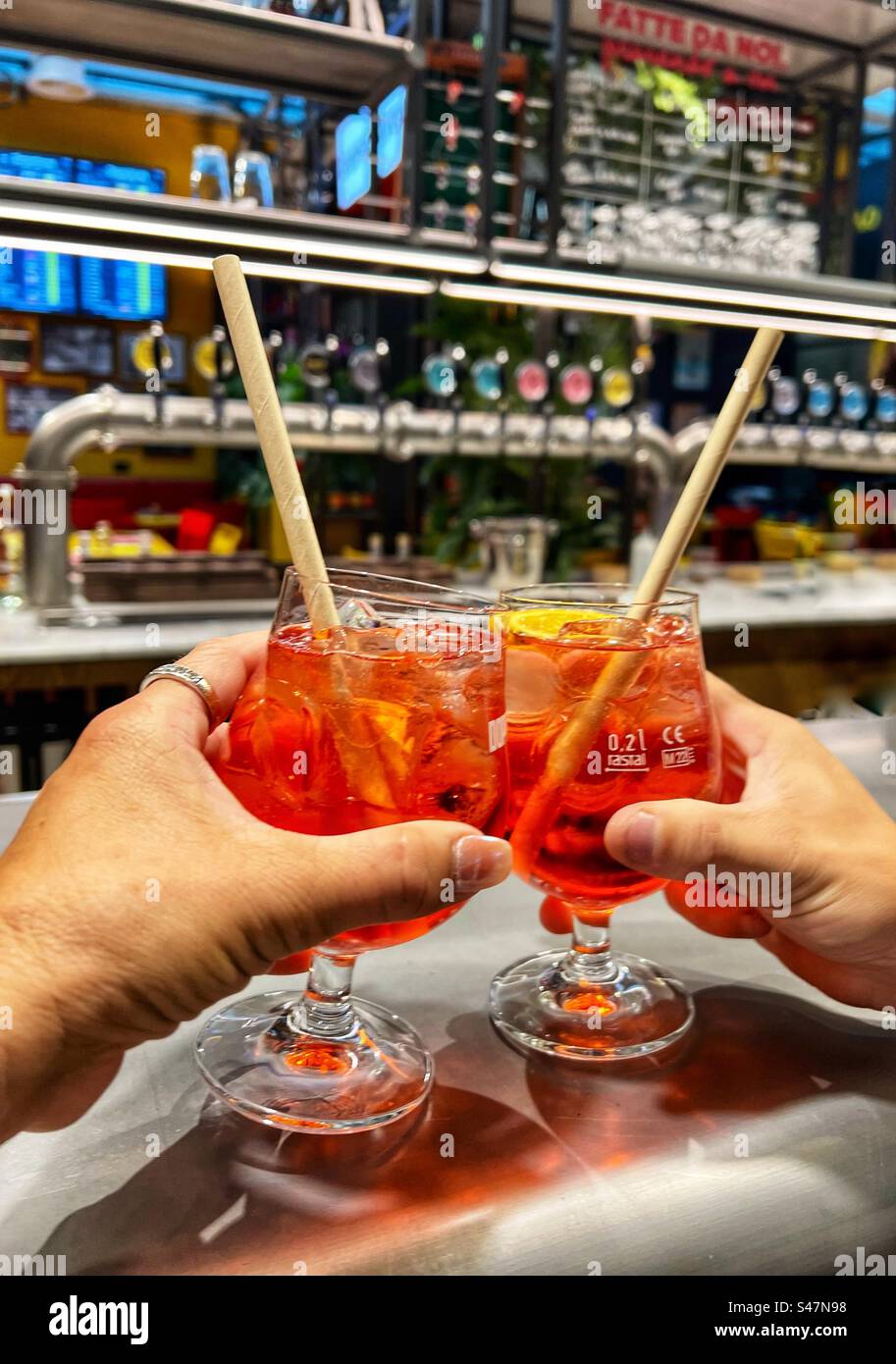 Cheers with Aperol spritz beverages in Rome. - Smartphone Captured Stock Image