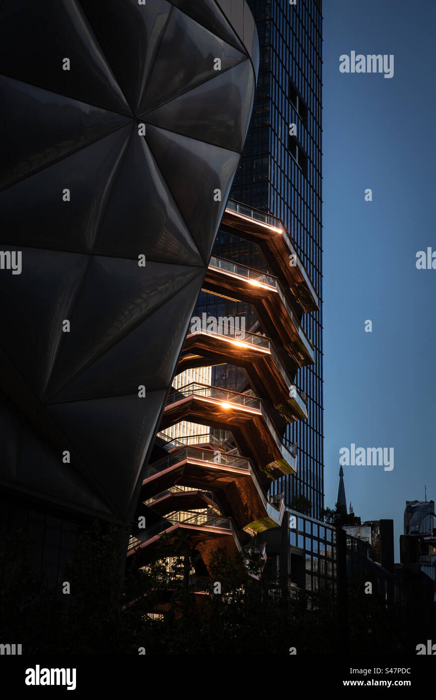 The Vessel structure at Hudson Yards in New York City with golden sunlight reflecting from a sunset - Smartphone Captured Stock Image