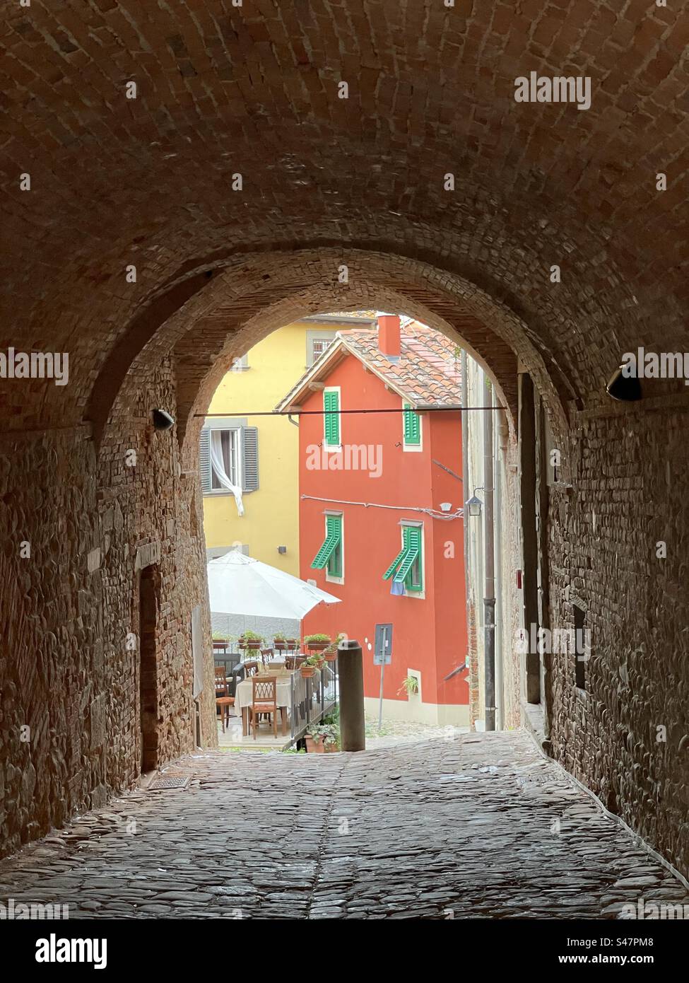 Café through an arch Montecarlo Lucca, Tuscany, Italy - Smartphone Captured Stock Image