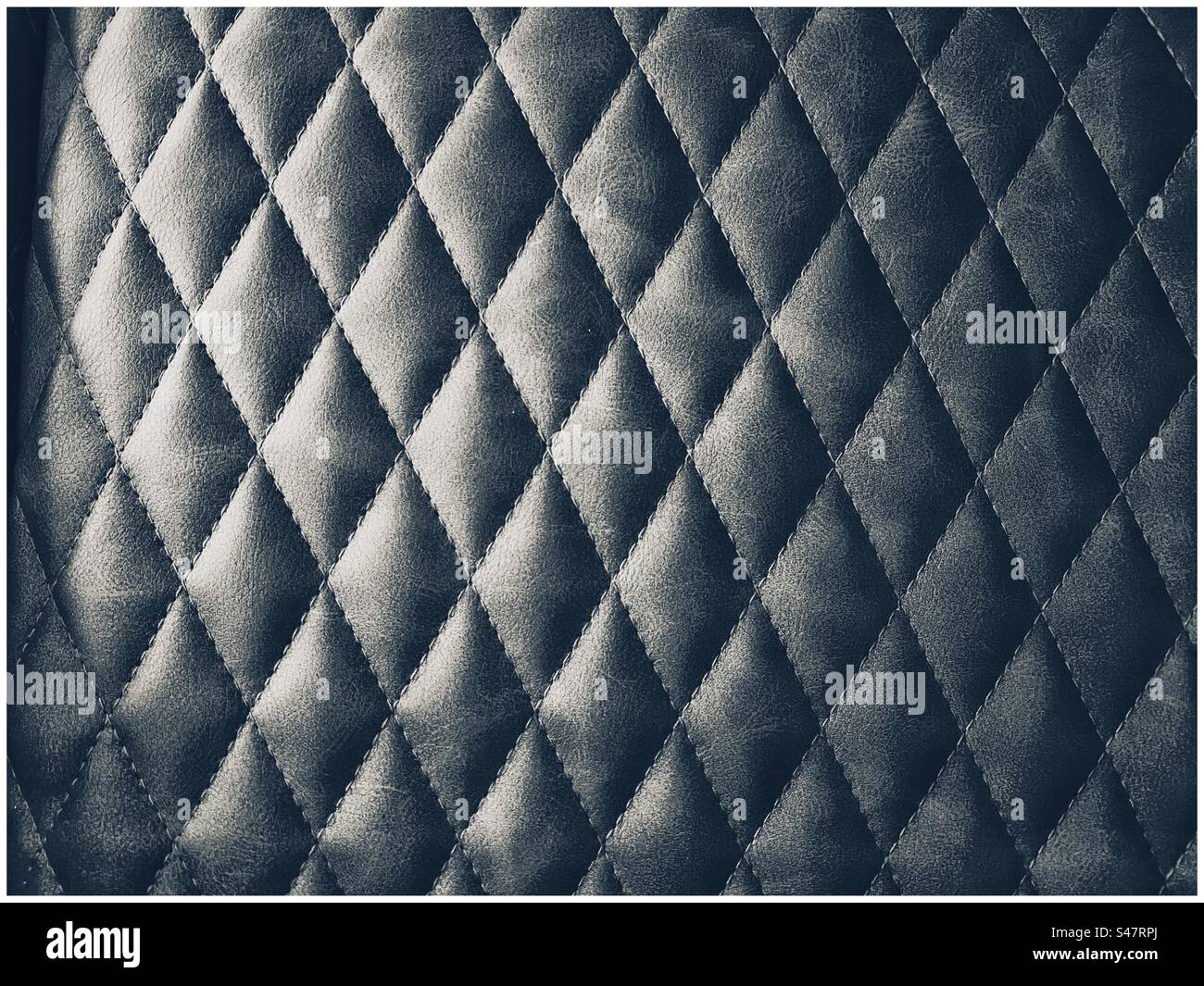 Side lit diamond patterned seat cover - Smartphone Captured Stock Image