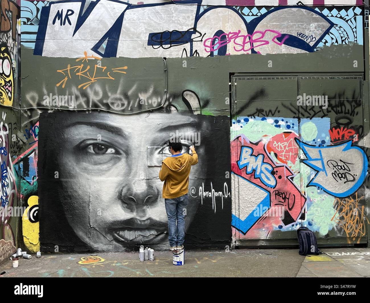 A graffiti artist paints an artwork on the Southbank in London, England Stock Photo Alamy