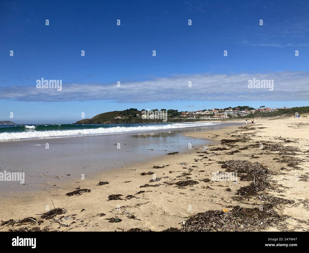 Deserted beach with blue sky and rocks - Smartphone Captured Stock Image