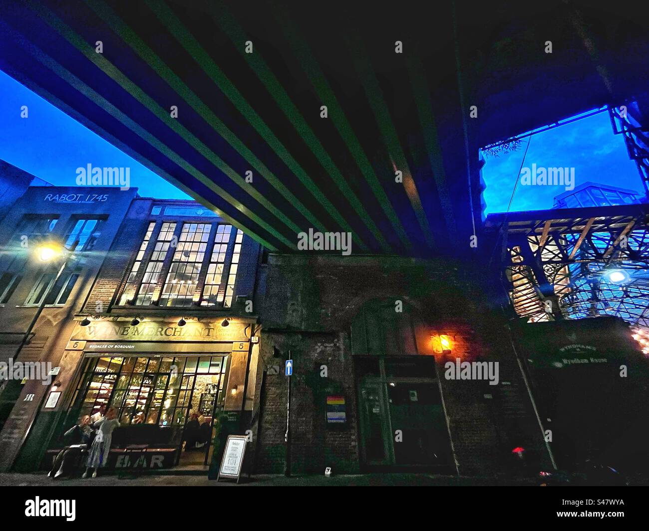 Under the railway tracks - a public house or pub and the canopy of Borough Market in London - Smartphone Captured Stock Image